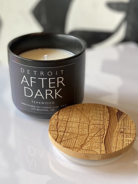 Detroit After Dark Candle by City Beautiful Co. Teakwood scent, black ceramic vessel with wood lid. Lid has City of Detroit map etched into the top