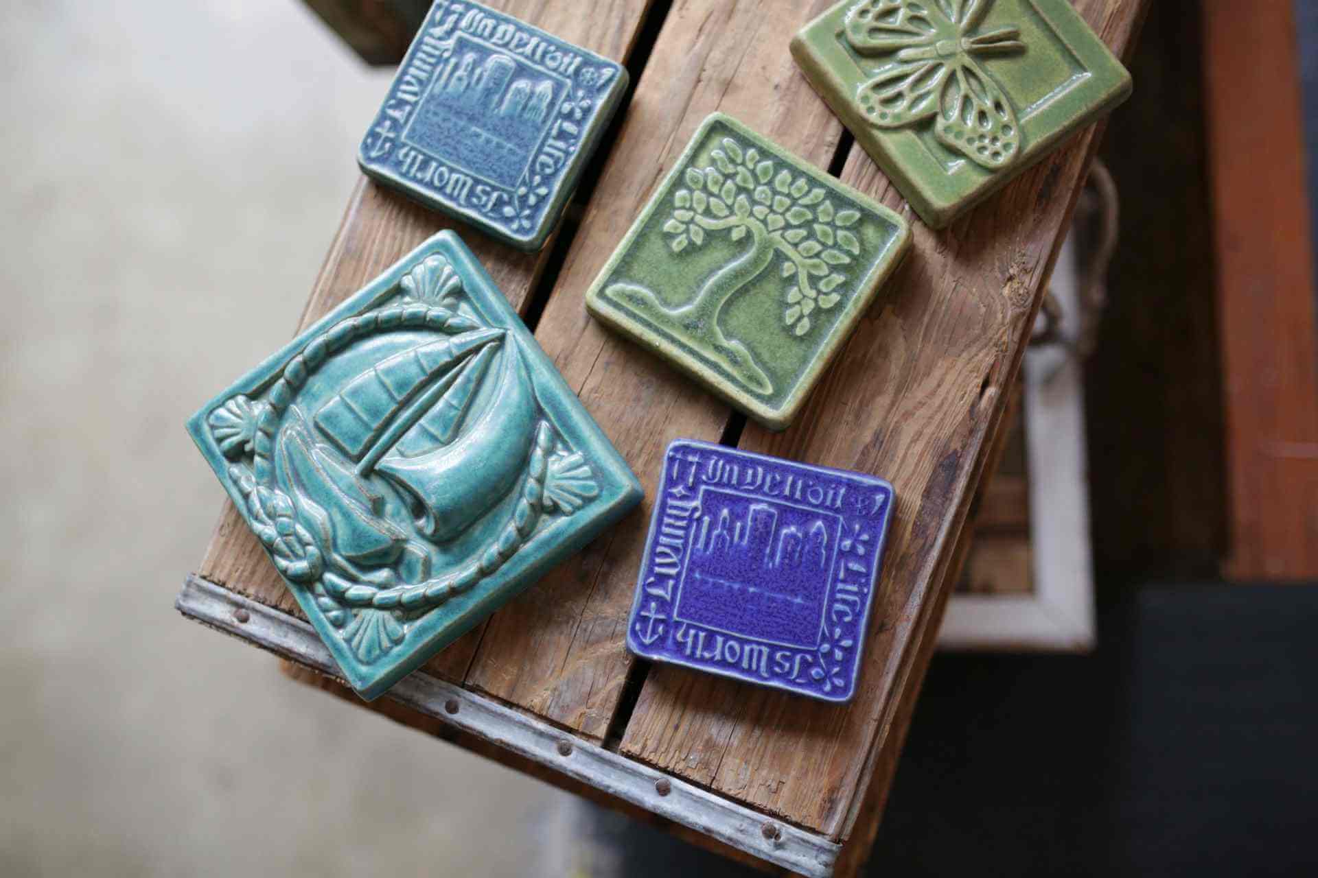 Five Pewabic Pottery tiles on a wood crate